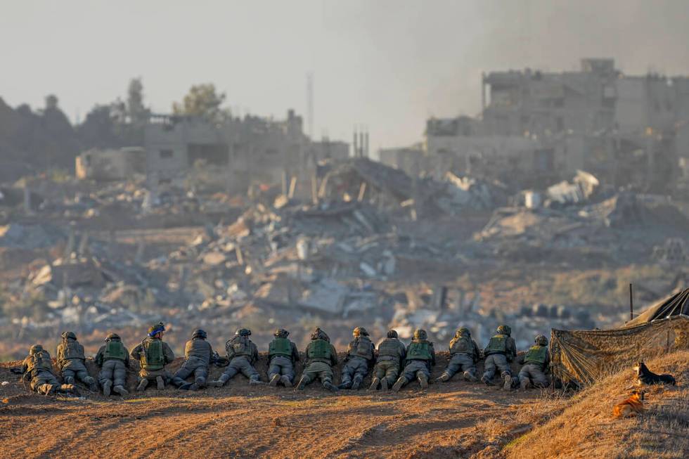 Israeli soldiers take positions near the Gaza Strip border, in southern Israel, Monday, Dec. 11 ...