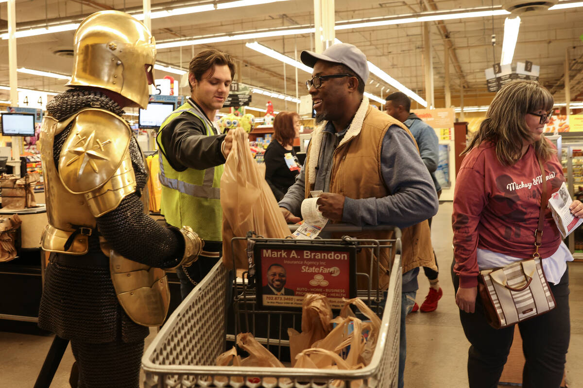 The Golden Knights talks to a customer at a Smith's on Monday during one of the Golden Knights ...
