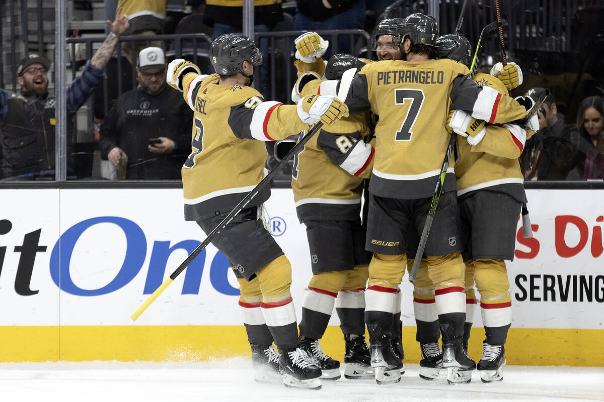 The Golden Knights surround their captain, right wing Mark Stone, after he scored a short-hande ...