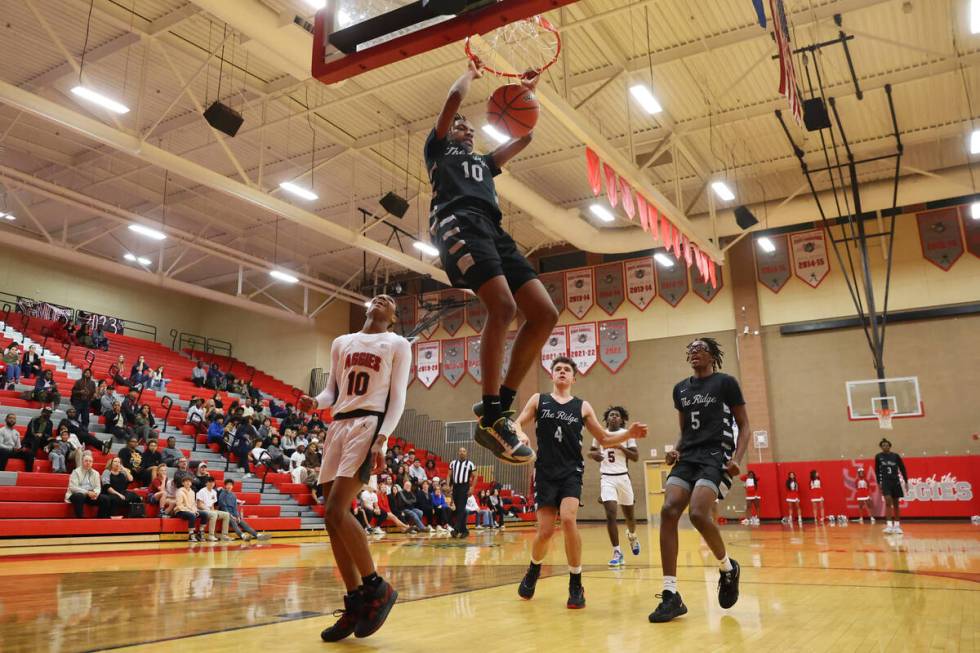 Shadow Ridge's Jalen Butler (10) dunks the ball as Arbor View's Tremmell Darden (10) looks on d ...