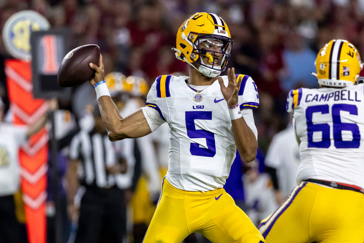 LSU quarterback Jayden Daniels (5) throws a pass during the first half of an NCAA college footb ...