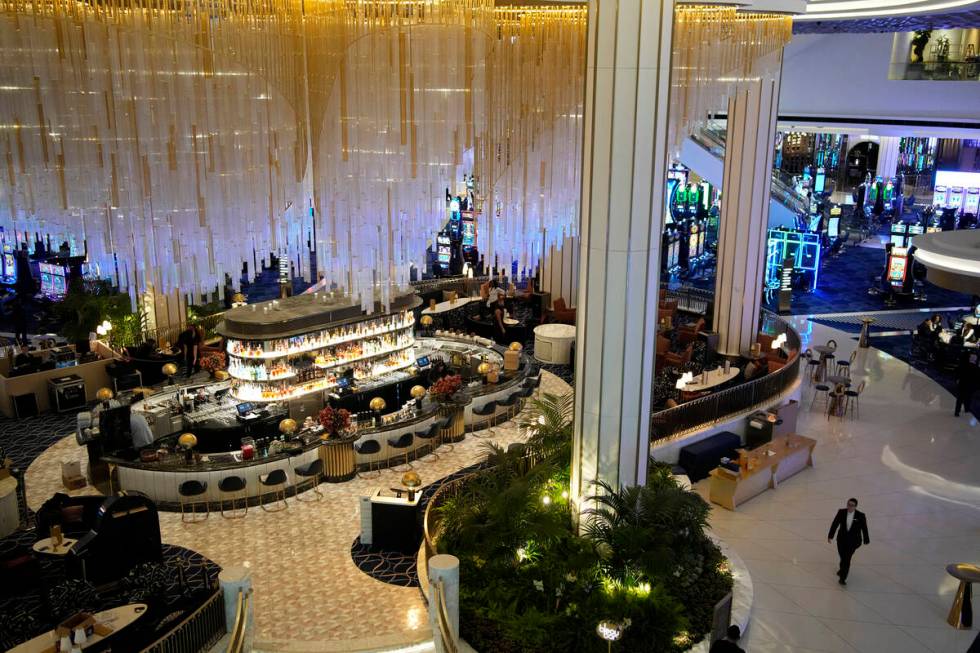 People walk by a bar in the casino at the Fontainebleau Las Vegas hotel-casino Tuesday, Dec. 12 ...