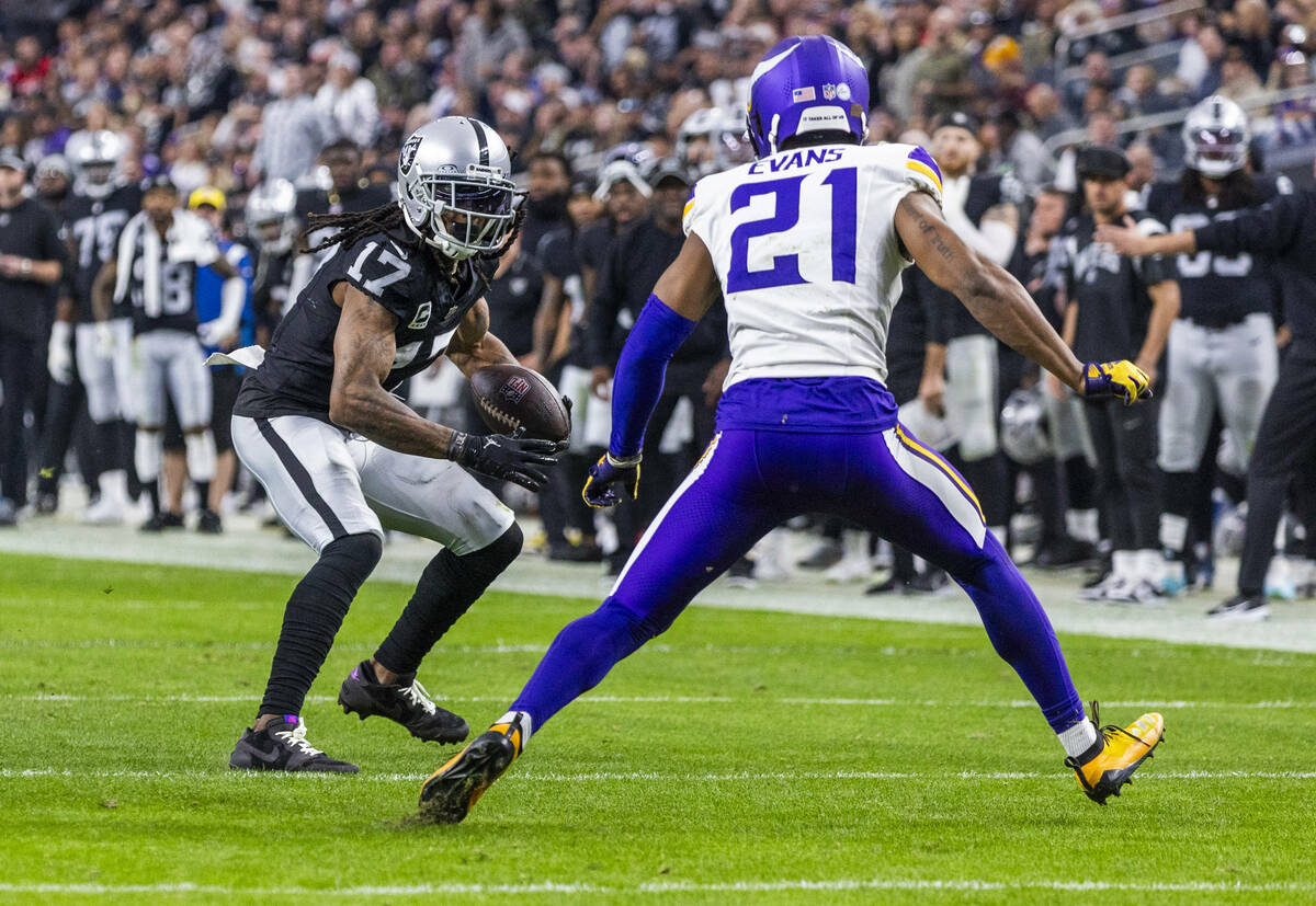 Raiders wide receiver Davante Adams (17) looks to get past Minnesota Vikings cornerback Akayleb ...