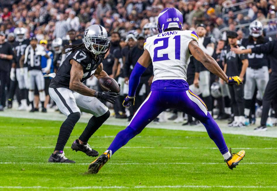 Raiders wide receiver Davante Adams (17) looks to get past Minnesota Vikings cornerback Akayleb ...