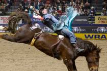 Jess Pope holds on to his horse while he competes in bareback riding on day six of the National ...