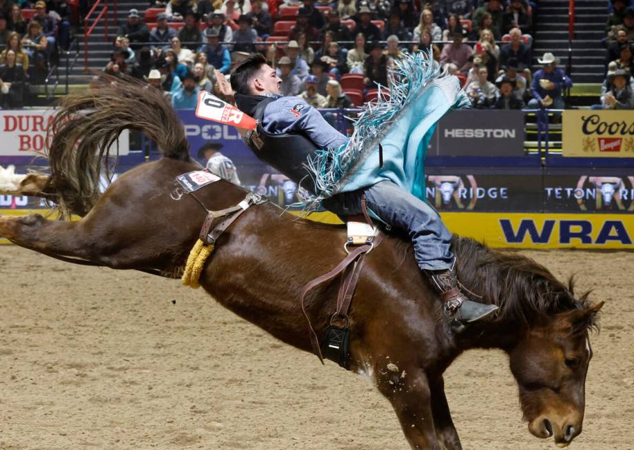 Jess Pope holds on to his horse while he competes in bareback riding on day six of the National ...