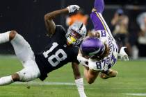 Minnesota Vikings tight end T.J. Hockenson (87) catches the ball in front of Raiders cornerback ...