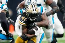 New Orleans Saints running back Alvin Kamara is tackled by Carolina Panthers' Marquis Haynes Sr ...