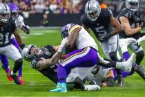 Raiders defensive end Maxx Crosby (98) stops Minnesota Vikings running back Alexander Mattison ...