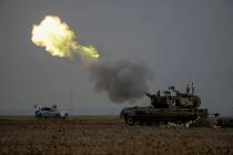 An Israeli mobile artillery unit fires a shell from southern Israel towards the Gaza Strip, in ...