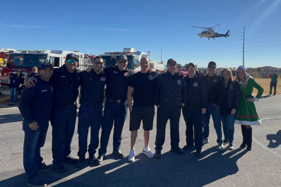 Firefighters from the Firefighters of Southern Nevada Burn Foundation distribute toys to studen ...