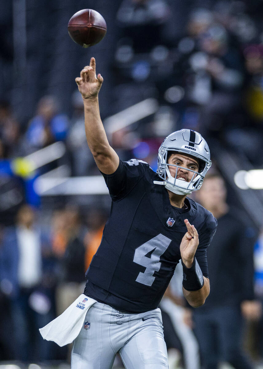 Raiders quarterback Aidan O'Connell (4) passes during warmups before the first half of their NF ...