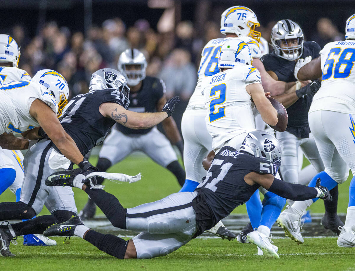 Raiders defensive end Malcolm Koonce (51) sacks Los Angeles Chargers quarterback Easton Stick ( ...