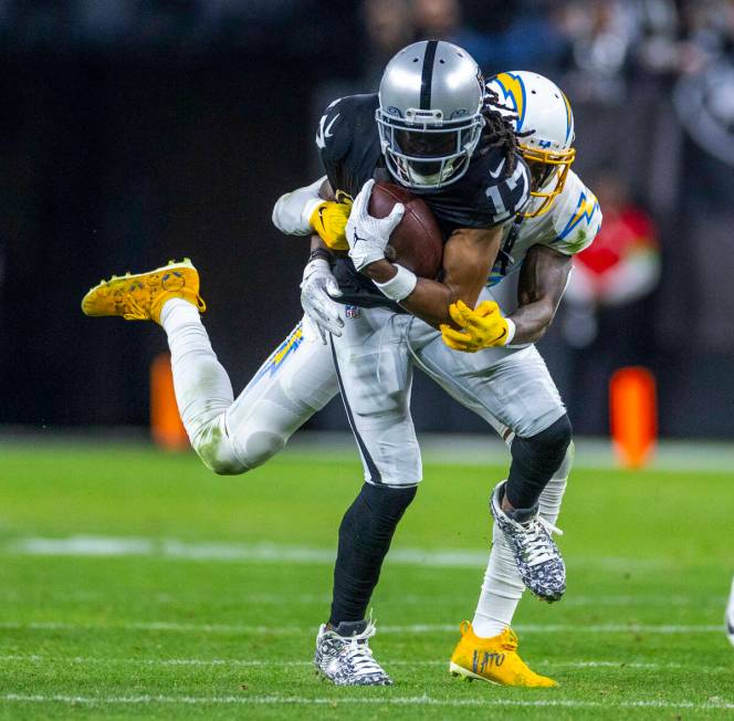 Raiders wide receiver Davante Adams (17) makes a reception against Los Angeles Chargers cornerb ...