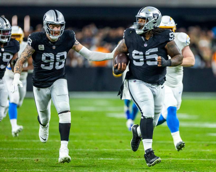 Raiders defensive tackle John Jenkins (95) runs back a Los Angeles Chargers fumble for a touch ...