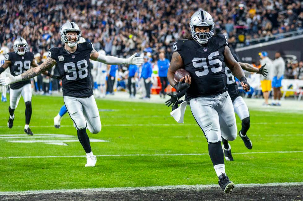 Raiders defensive tackle John Jenkins (95) runs back a Los Angeles Chargers fumble for a touch ...