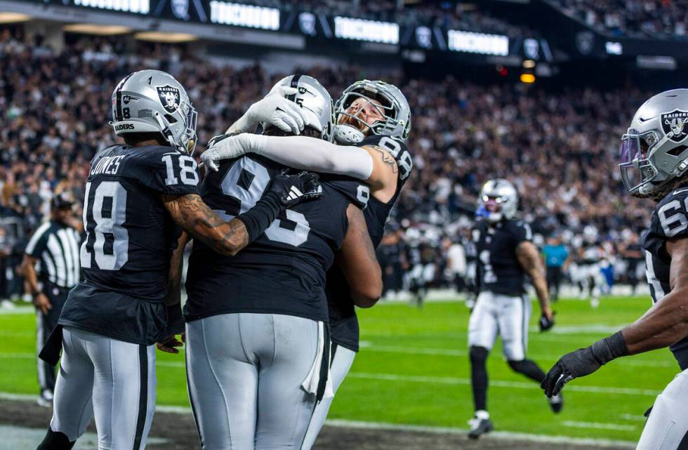 Raiders defensive tackle John Jenkins (95) celebrates a touchdown with defensive end Maxx Crosb ...