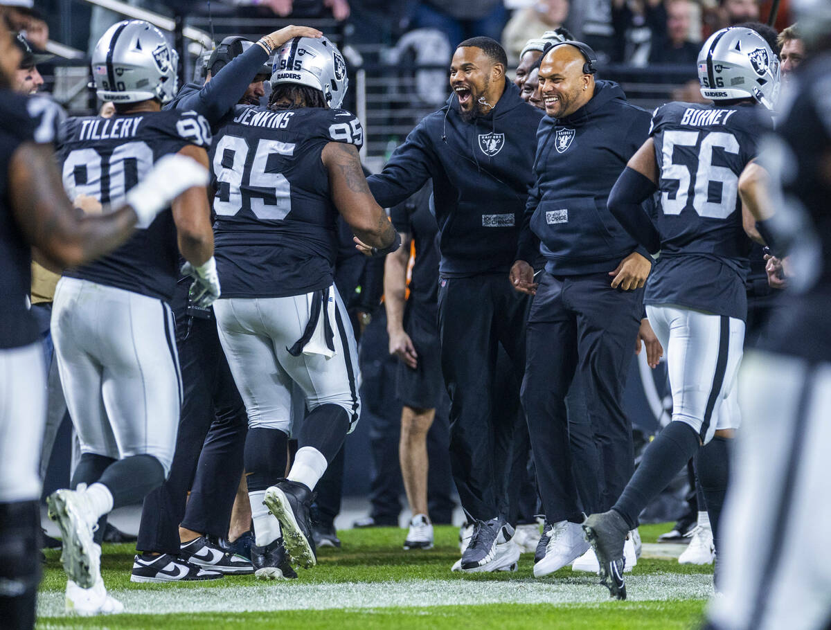 Raiders interim head coach Antonio Pierce and others celebrate a touchdown by defensive tackle ...