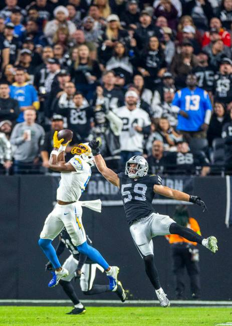 Los Angeles Chargers wide receiver Joshua Palmer (5) gets high up for a reception against Raide ...