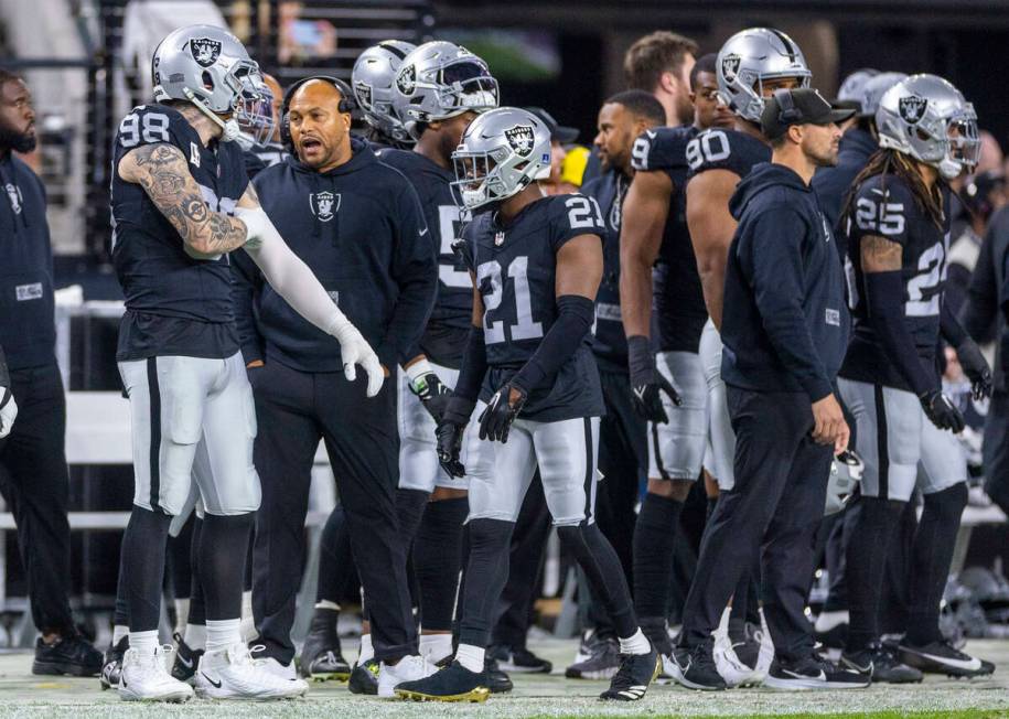 Raiders defensive end Maxx Crosby (98) talks with interim head coach Antonio Pierce during the ...