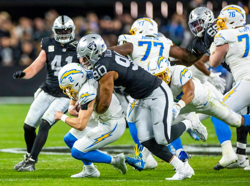 Los Angeles Chargers quarterback Easton Stick (2) is sacked by Raiders defensive tackle Jerry T ...