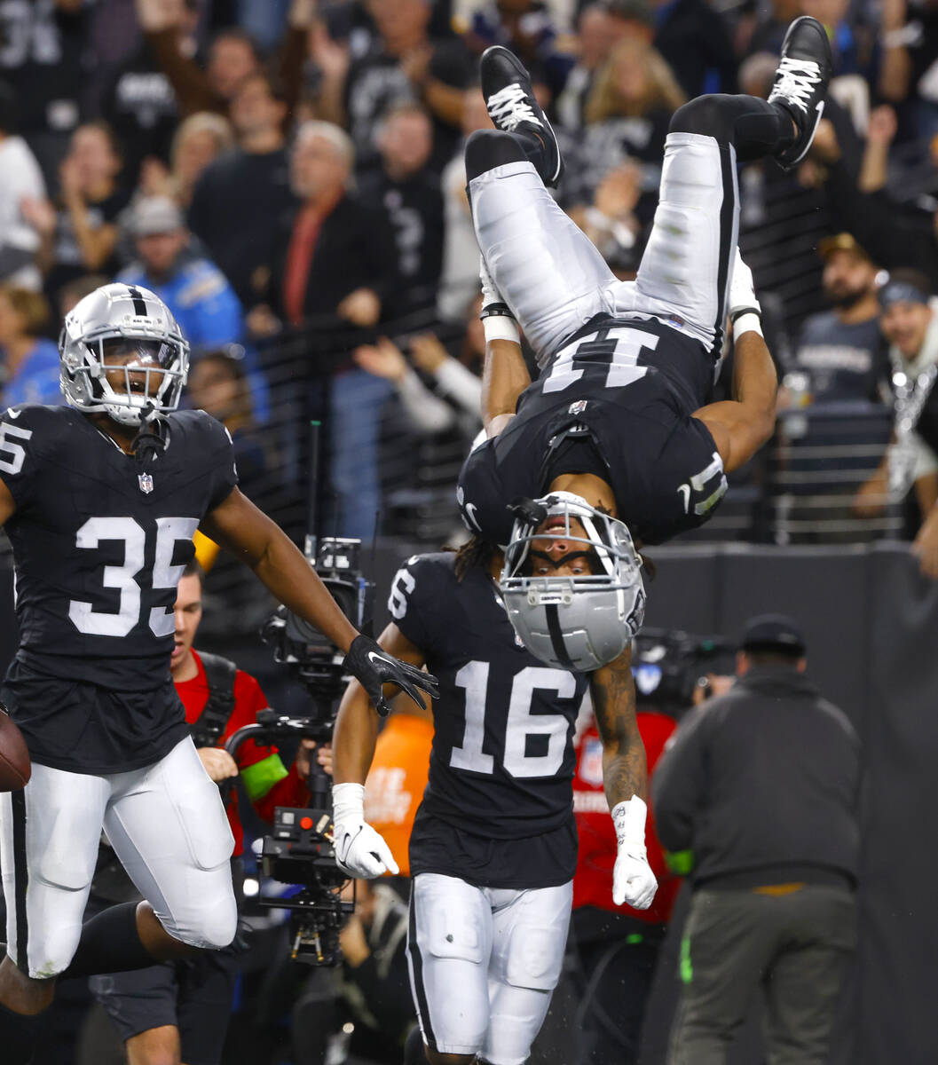 Raiders wide receiver Tre Tucker (11) celebrates his touchdown as running back Zamir White (35) ...