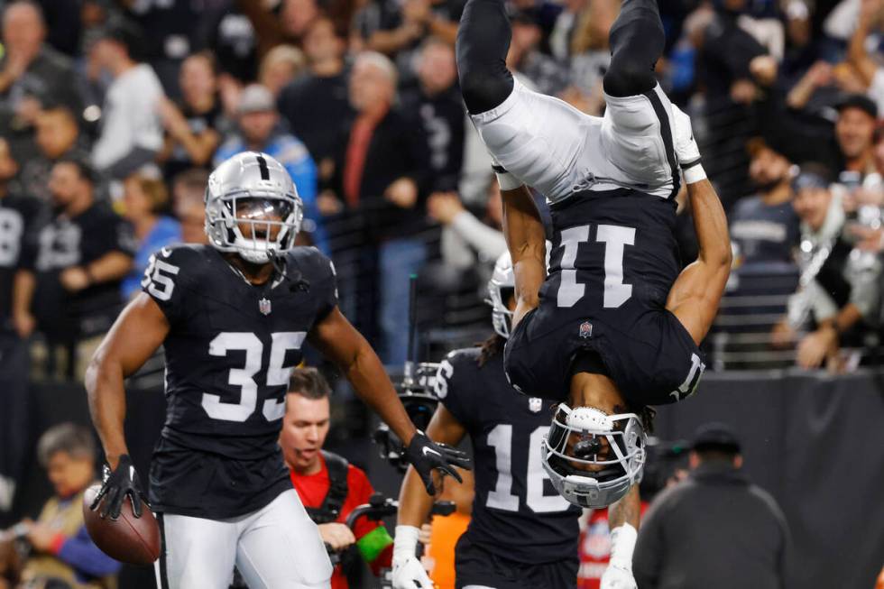 Raiders wide receiver Tre Tucker (11) celebrates his touchdown as running back Zamir White (35) ...