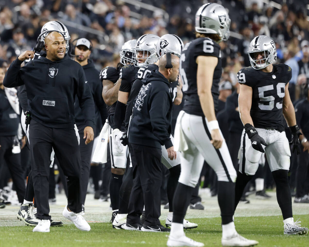 Raiders Interim Coach Antonio Pierce communicates with his players during the second half of an ...