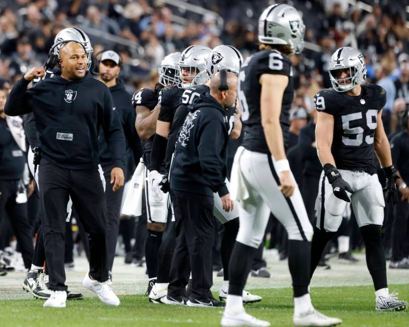 Raiders Interim Coach Antonio Pierce communicates with his players during the second half of an ...