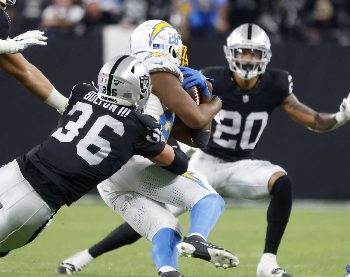 Raiders linebacker Curtis Bolton (36) takes down Los Angeles Chargers running back Isaiah Spill ...