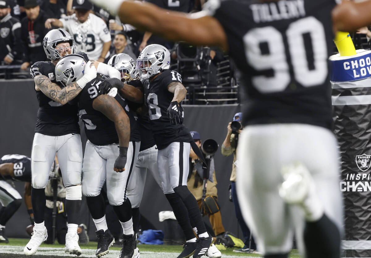 Raiders defensive tackle John Jenkins (95) celebrates his touchdown with his teammates after re ...