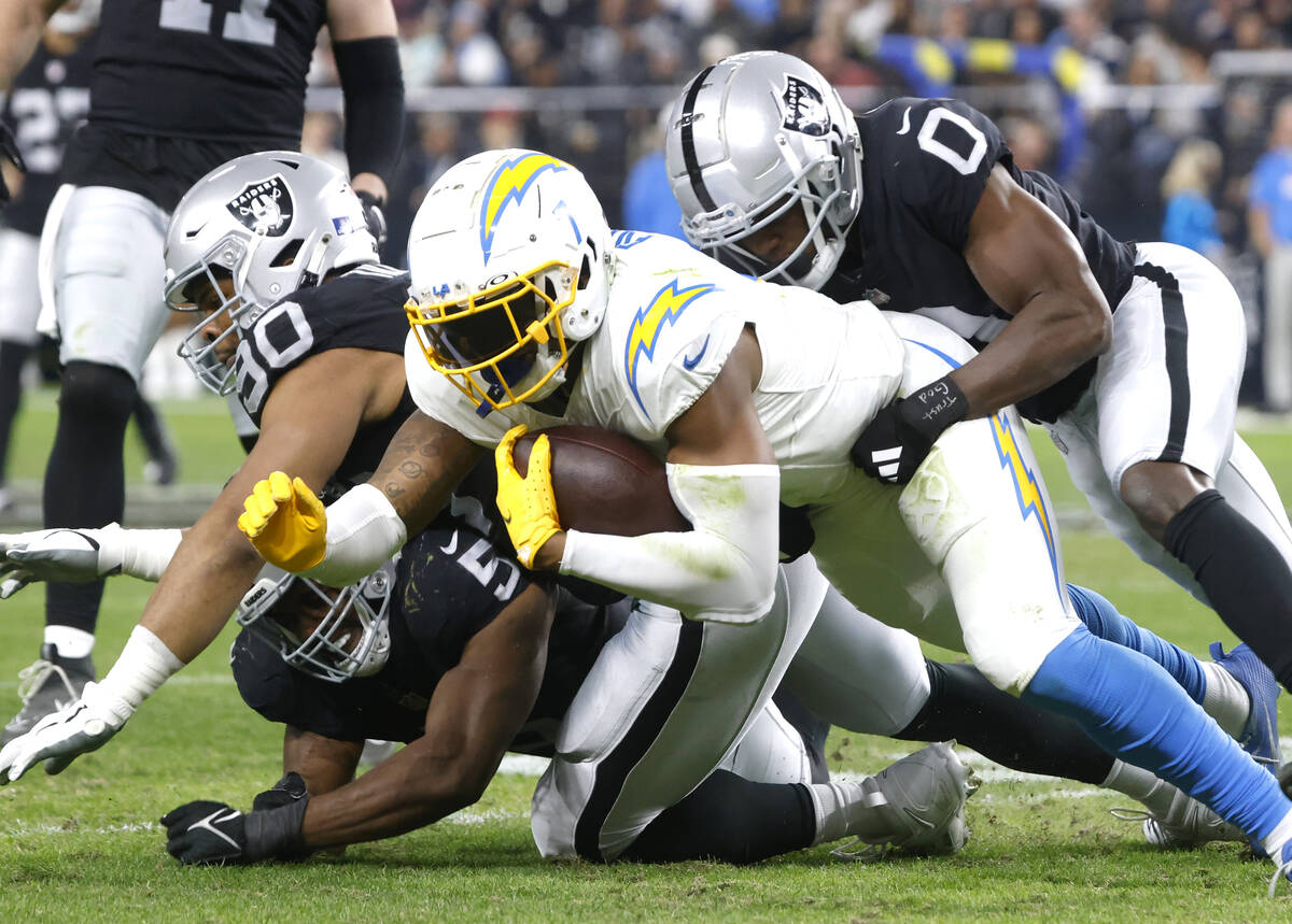 Los Angeles Chargers tight end Gerald Everett (7) is taken down by Raiders defense during the s ...