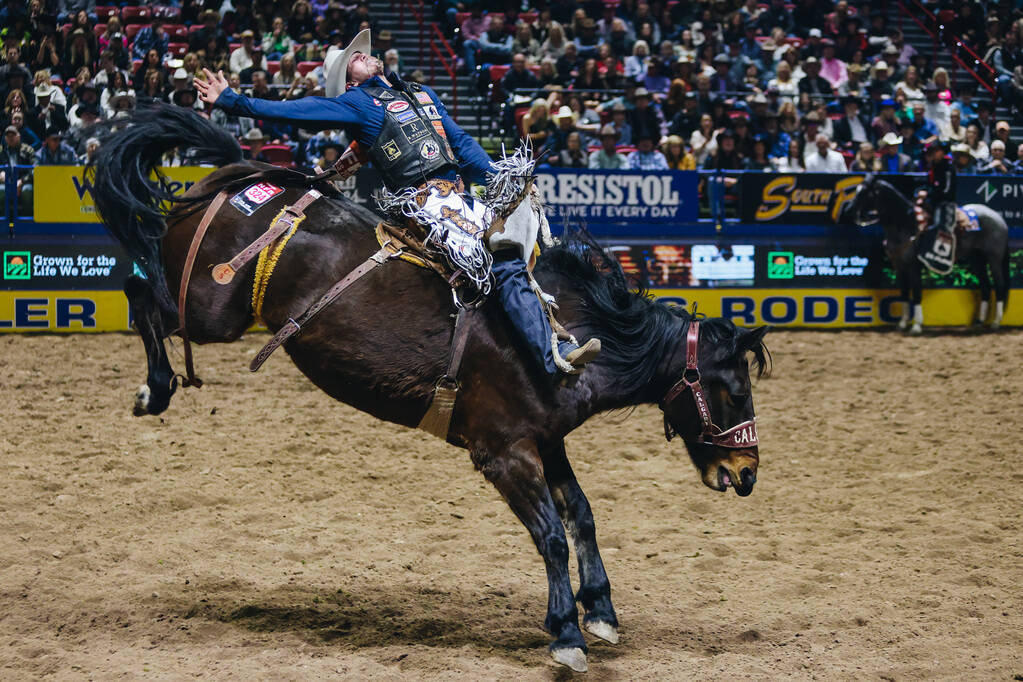 Chase Brooks stays on the horse during the National Finals Rodeo at the Thomas & Mack Cente ...