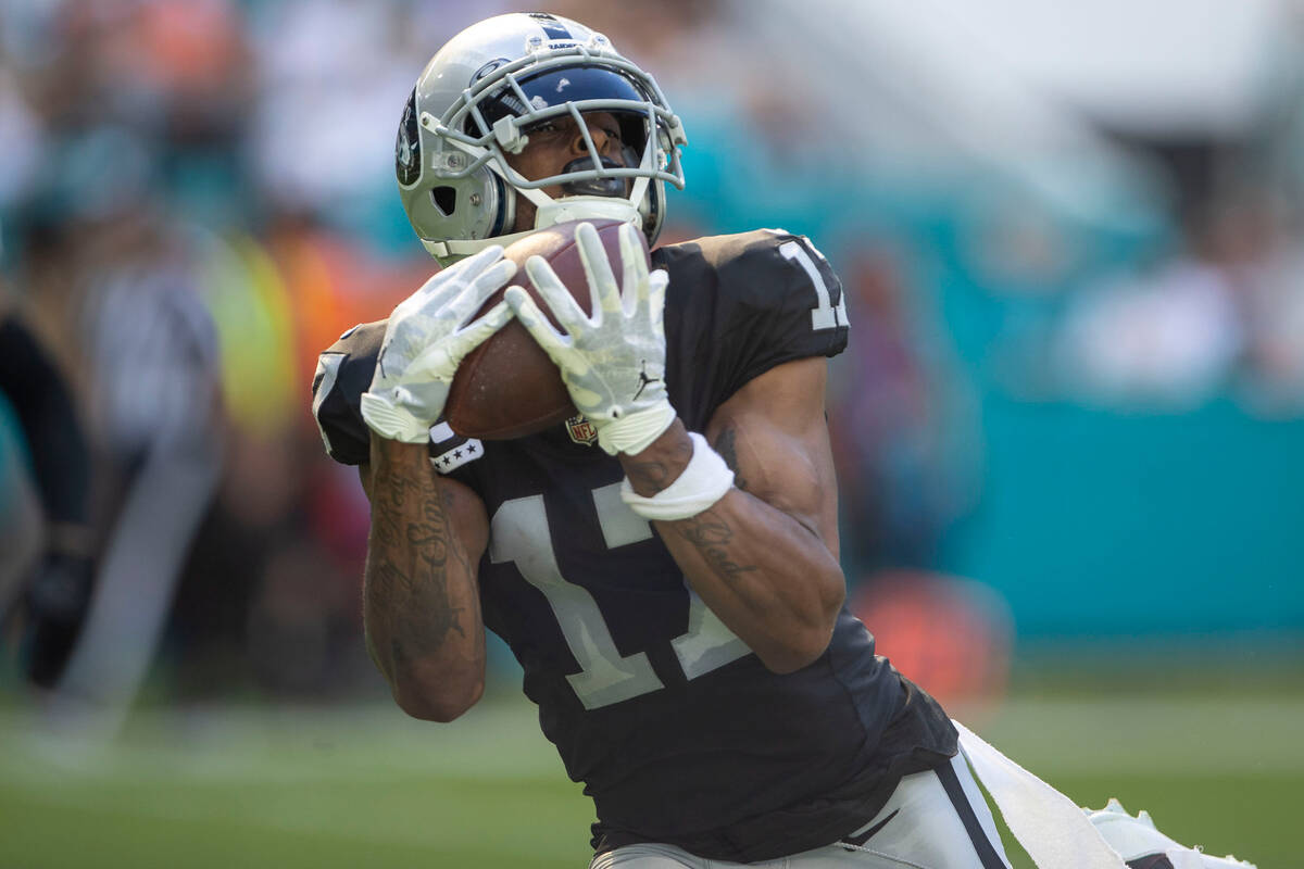 Raiders wide receiver Davante Adams (17) makes a catch and heads to the end zone during the fir ...