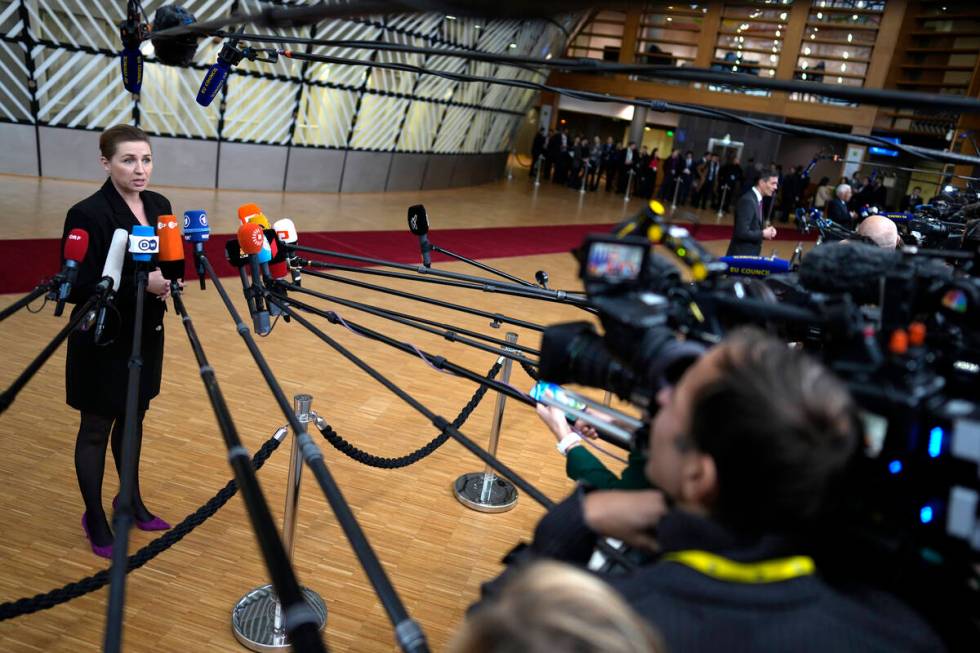 Denmark's Prime Minister Mette Frederiksen speaks with the media as she arrives for an EU summi ...