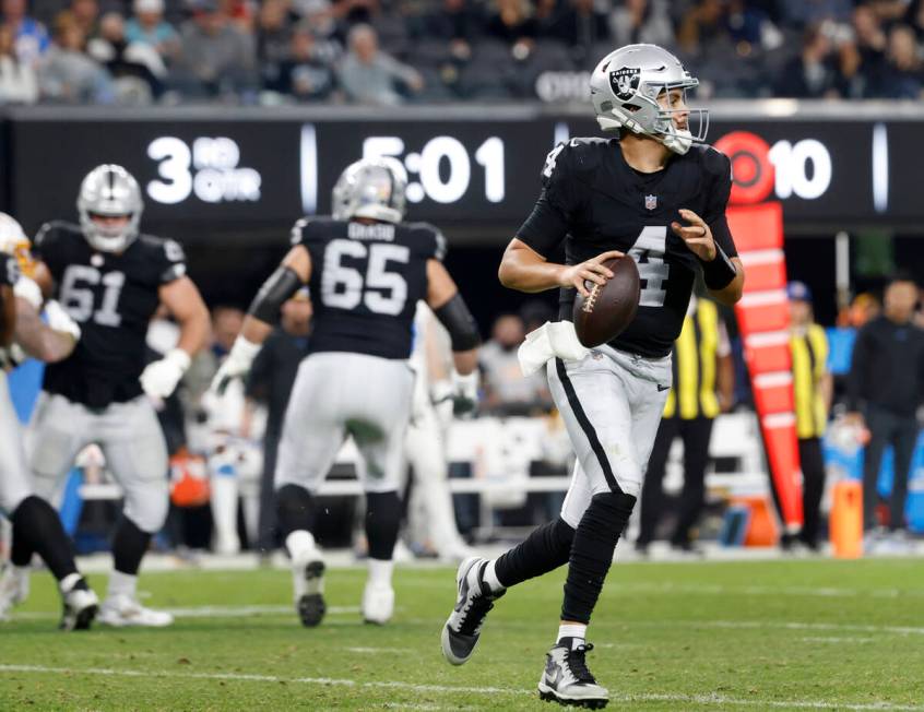 Raiders quarterback Aidan O'Connell (4) prepares to throw a pass against Los Angeles Chargers d ...