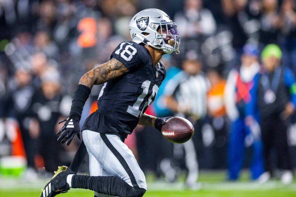 Raiders cornerback Jack Jones (18) runs in an interception against the Los Angeles Chargers for ...