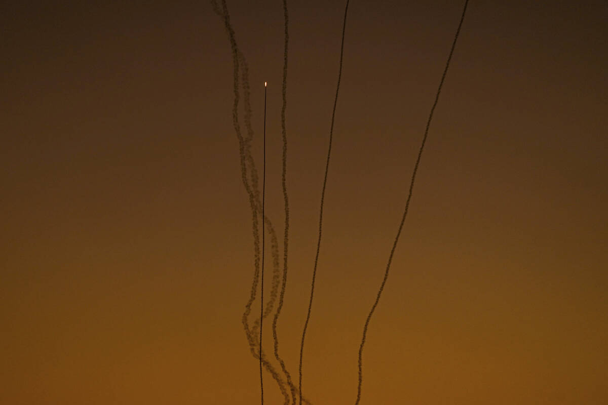 Rockets are fired toward Israel from the Gaza Strip, as seen from southern Israel, Friday, Dec. ...