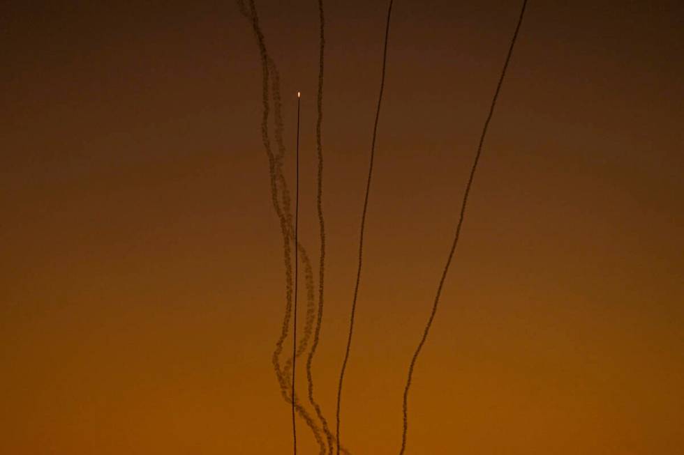 Rockets are fired toward Israel from the Gaza Strip, as seen from southern Israel, Friday, Dec. ...