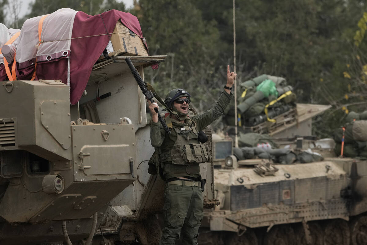 An Israeli soldier reacts after returning from Gaza, at a staging area near the Israeli-Gaza bo ...