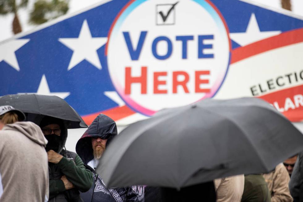 People wait in line to cast their vote at the Centennial Center polling place in Las Vegas, Tue ...