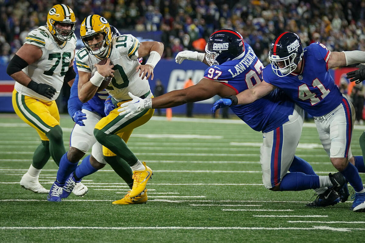 Green Bay Packers quarterback Jordan Love (10) runs with the ball during an NFL football game a ...