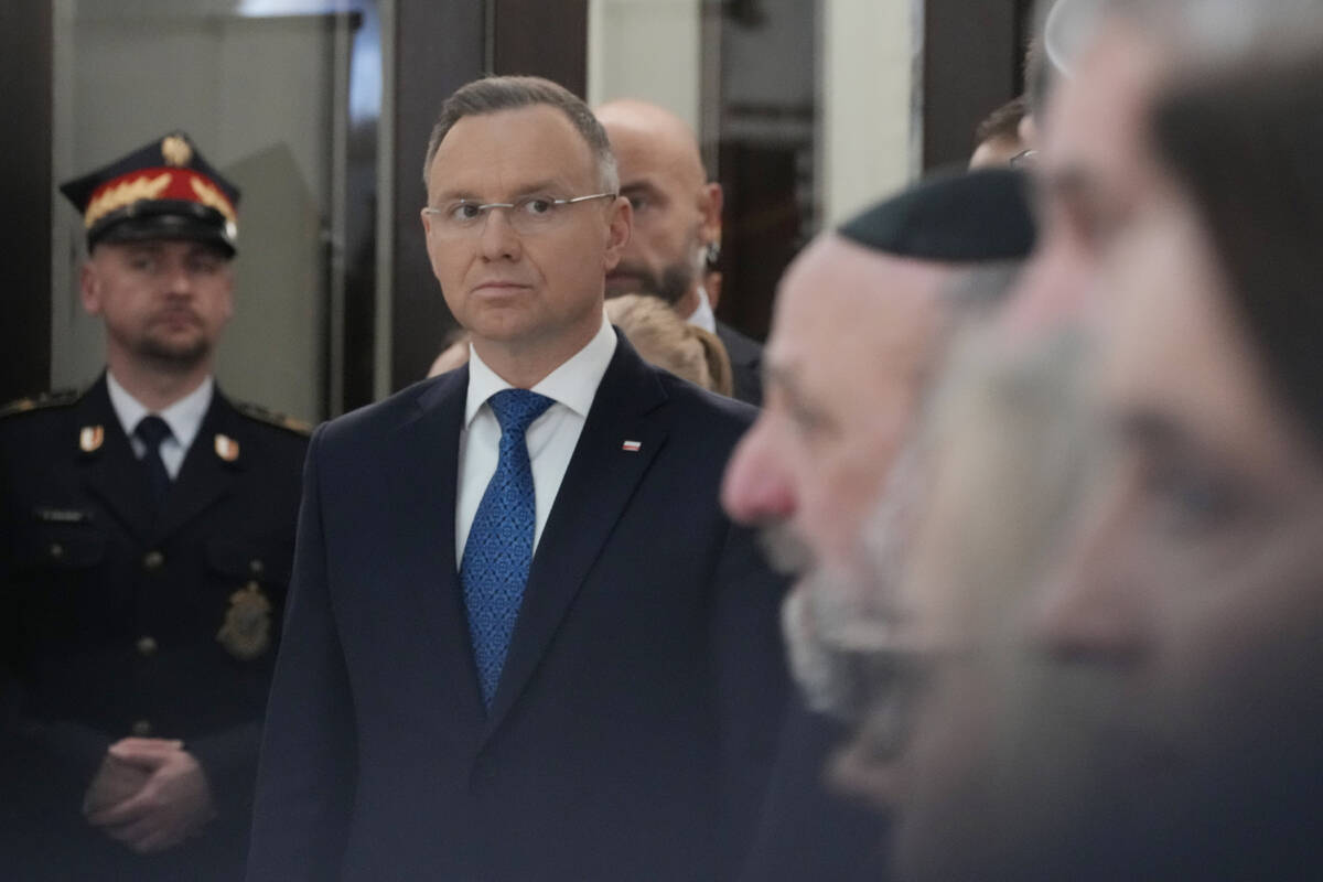 Members of parliament, President Andrzej Duda, second left, and the Polish Jewish community com ...