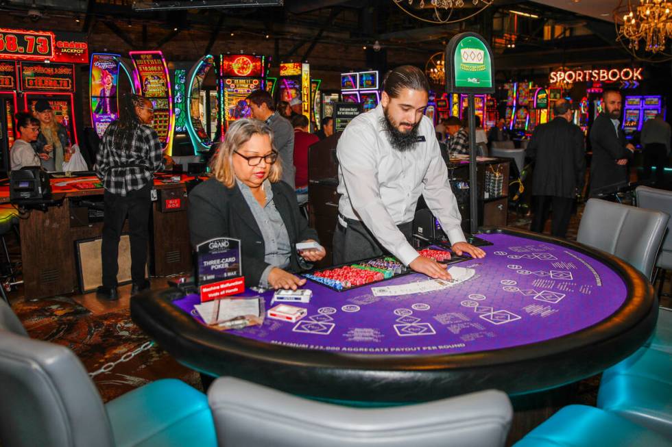 Carlos Sotelo and Shaliza Murphy prepare a table at the Downtown Grand Hotel and Casino on Frid ...