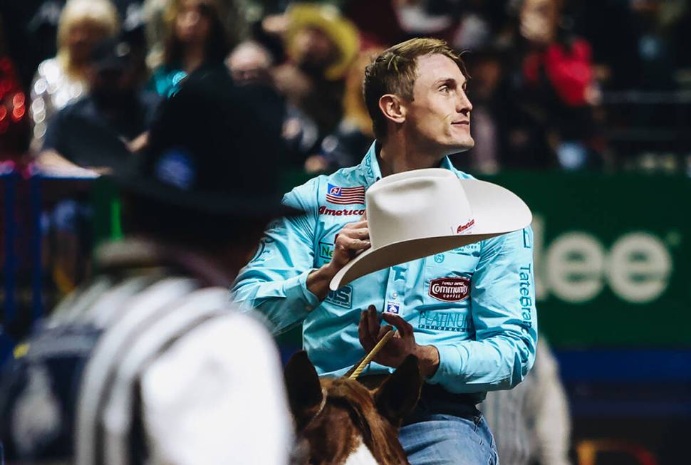 Tuf Cooper gestures towards the crowd during the tie down roping event at the National Finals R ...