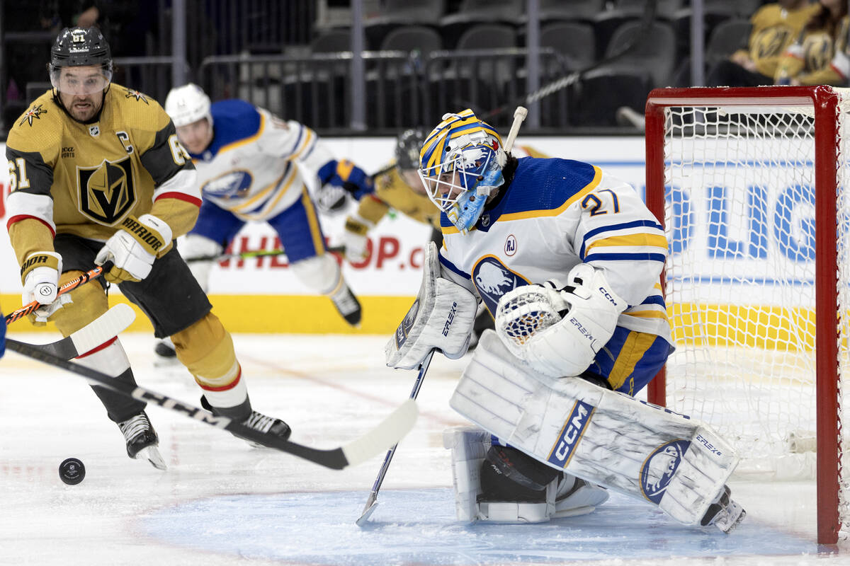 Golden Knights right wing Mark Stone (61) watches as Sabres goaltender Devon Levi (27) saves hi ...