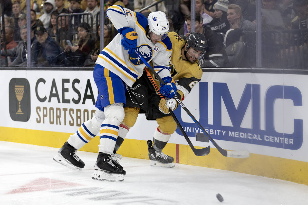 Golden Knights left wing William Carrier (28) battles for the puck against Sabres defenseman Ow ...