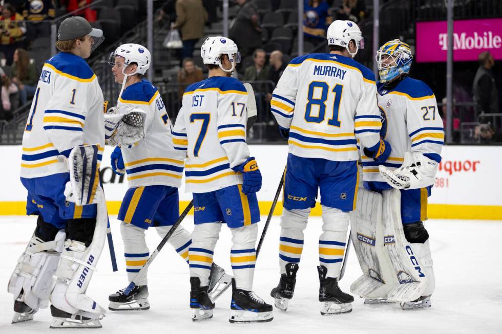 The Sabres congratulate goaltender Devon Levi (27) on their win in an NHL hockey game against t ...