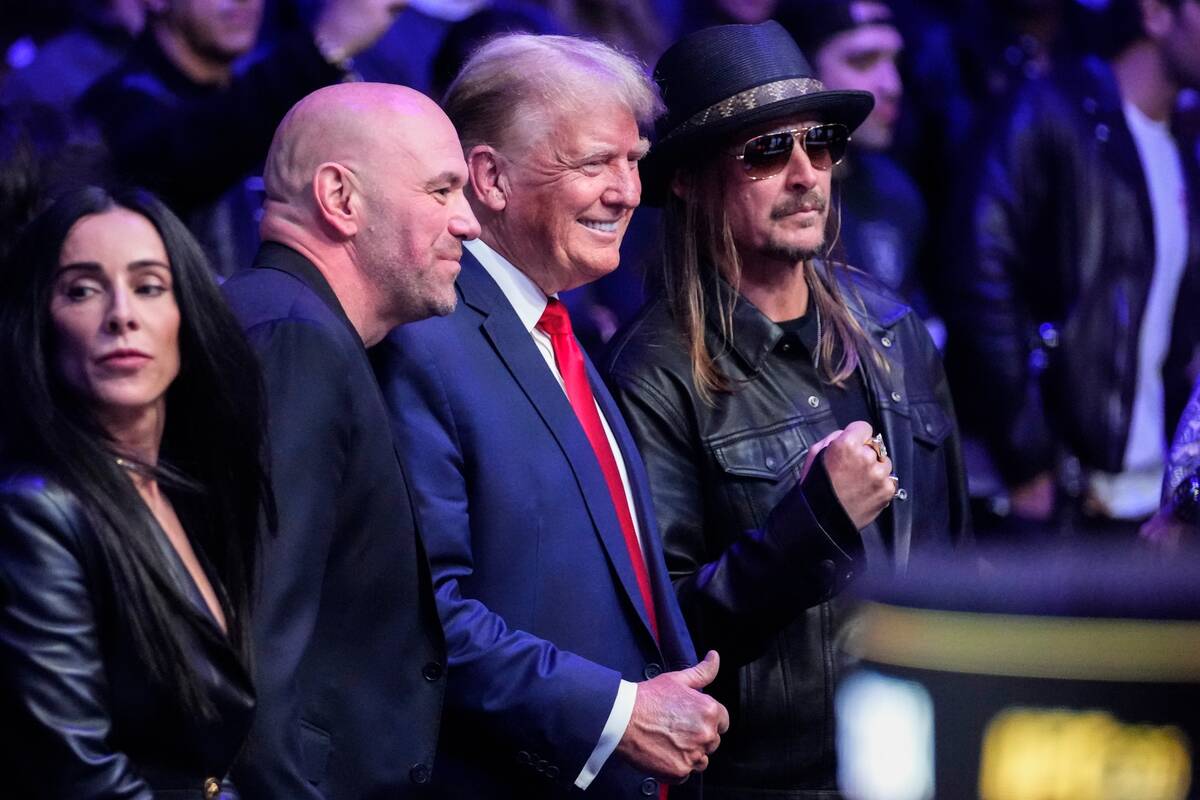 FILE - UFC president Dana White, second from left, and Kid Rock, right, pose for photographs wi ...