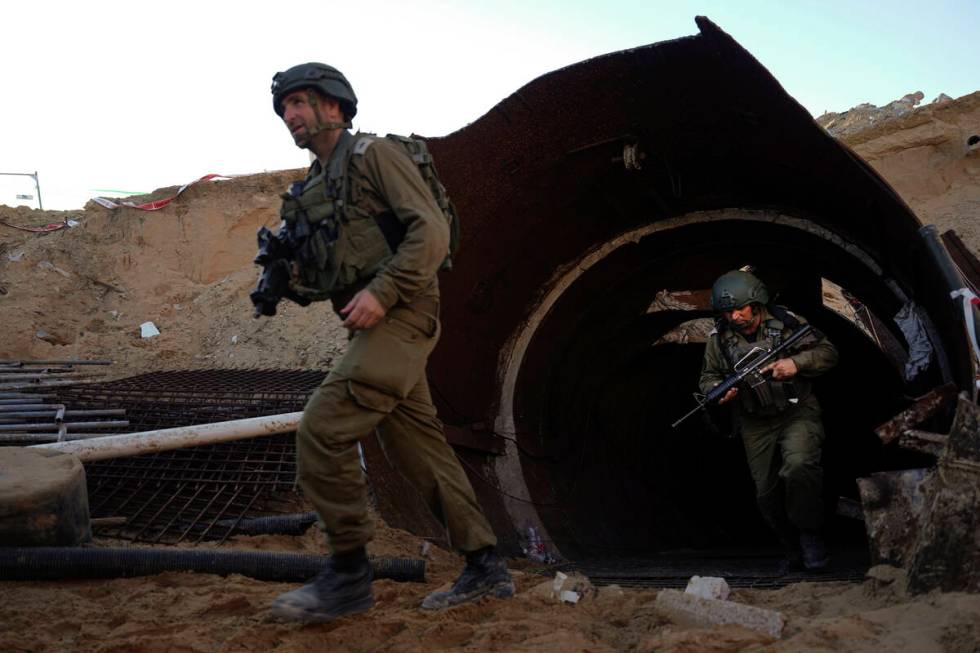 Israeli soldiers exit a tunnel that the military says Hamas militants used to attack the Erez c ...